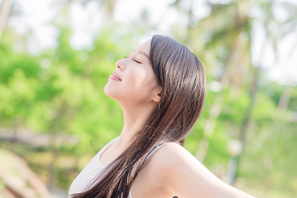 istock young woman raising her arms 547451532