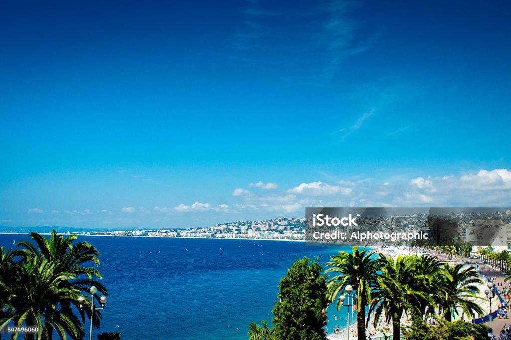 Nice France beach The beach on the Mediterranean sea in Nice, France.  This is on a hot July Sumers day with many holiday makers and tourists on the beach sunbathing. French Riviera Stock Photo