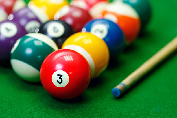 istock Billiard balls in a green pool table 547496826