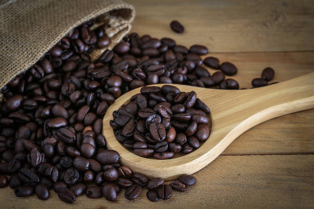istock Coffee beans on wood background 547497198
