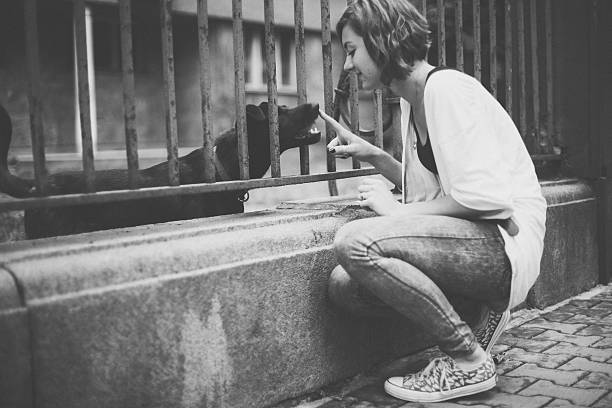 Teenage girl at the street enjoying a dog