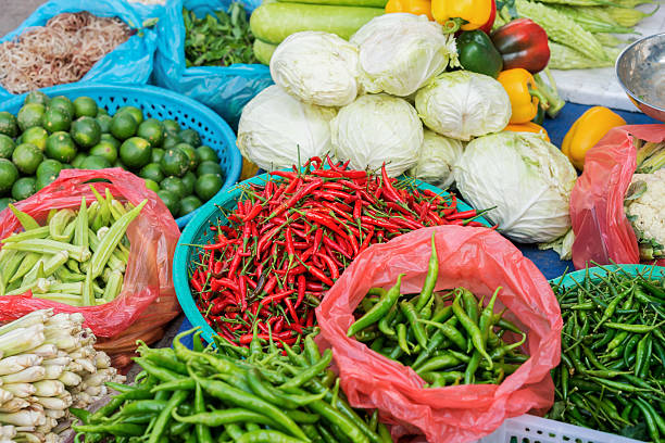 asian street market selling pod pepper lime and cabbage - lime market vietnam fruit imagens e fotografias de stock