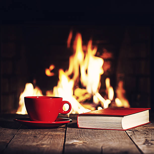 istock Red cup of coffee or tea and old book 547503548