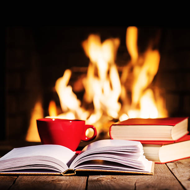 istock Red cup of coffee or tea and old books 547503606