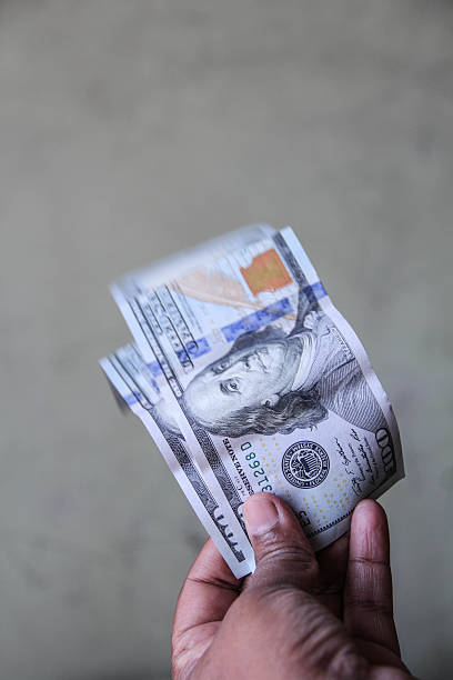 istock Human hand is holding a hundred dollar bank note 547503798