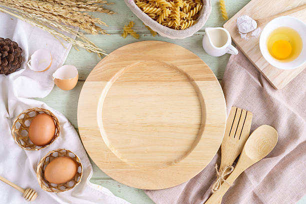 istock Empty dish with ingredients and equipment on green wooden table 547504950