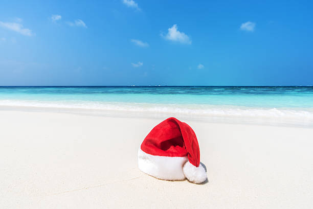 istock Santa hat on the sunny beach 547505102