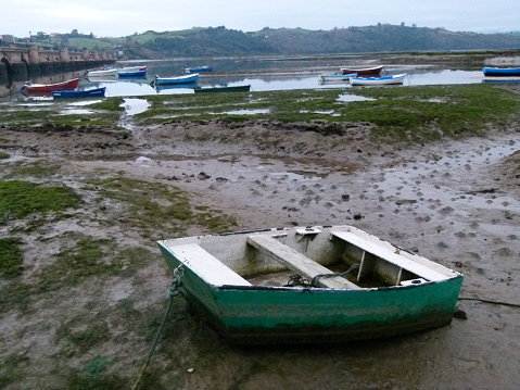 Sad scene of some small boats abandoned.