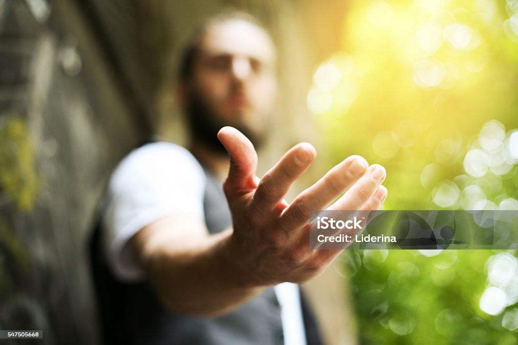 Helping hand. Giving a helping hand, asking or offering help close-up shot of a Caucasian man in a business suit. Consoling Stock Photo