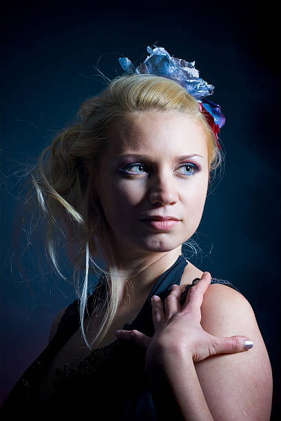 istock smiling young woman over blue holidays dark background 547509514