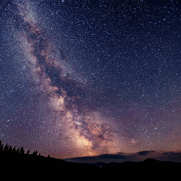 istock fantastic winter meteor shower and the snow-capped mountains 547509616