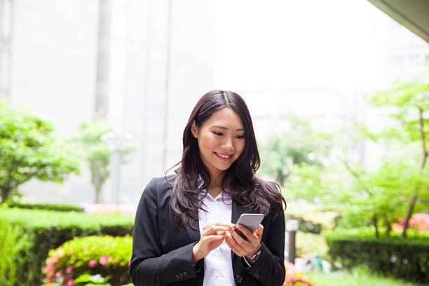istock Business woman outdoors working on her mobile phone 547510778