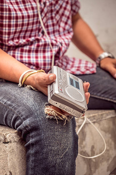 istock tape cassette player listening to music outdoors. with retro filter 547510846