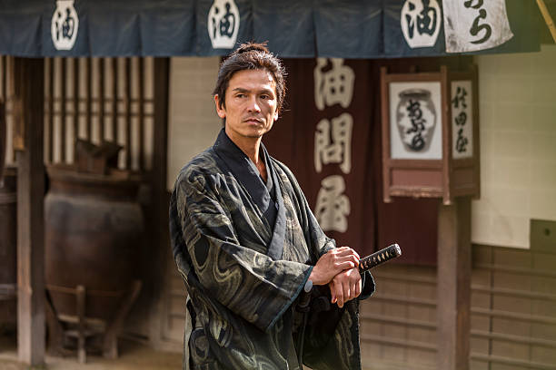 istock Ronin Samurai Warrior With Katana in a Traditional Japanese Village 547511330