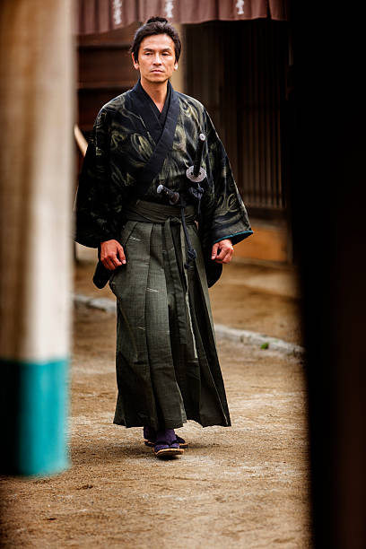 istock Ronin Samurai Warrior With Katana in a Traditional Japanese Village 547511584