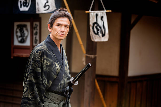 istock Ronin Samurai Warrior With Katana in a Traditional Japanese Village 547511748