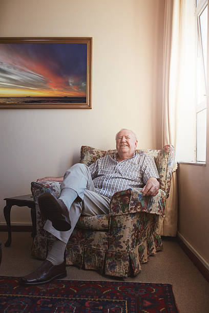 istock Old man relaxing on an arm chair at home 547512768