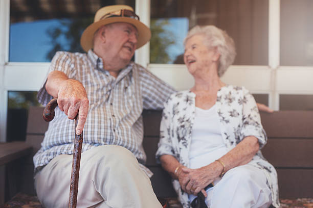 istock Loving elderly couple relaxing outdoors on a bench 547513106