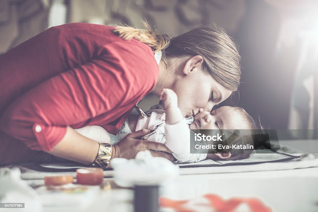 At the workplace Young fashion designer is visiting her workplace with her little daughter Baby - Human Age Stock Photo