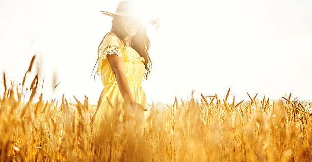 istock beautiful young woman posing in wheat field 547519548