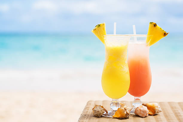 istock Two tropical fresh juices on white sandy beach 547520092
