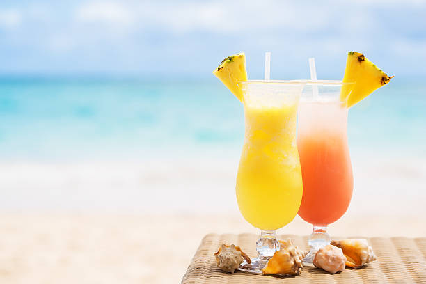 Two tropical fresh juices on white sandy beach Two tropical fresh juices on white sandy beach maldivian culture stock pictures, royalty-free photos & images