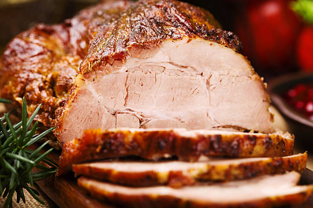 istock Roast pork with herbs and vegetables. 547520552