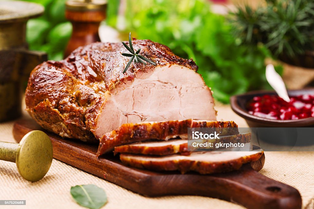 Roast pork with cranberry dip, basil, coriander and rosemary. Pork Stock Photo