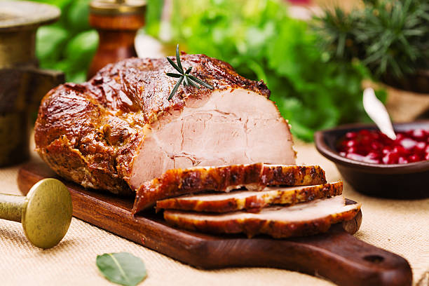 Roast pork with cranberry dip, basil, coriander and rosemary. Roast pork with cranberry dip, basil, coriander and rosemary. loin stock pictures, royalty-free photos & images