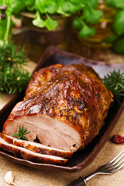 istock Roast pork with herbs and vegetables. 547520752