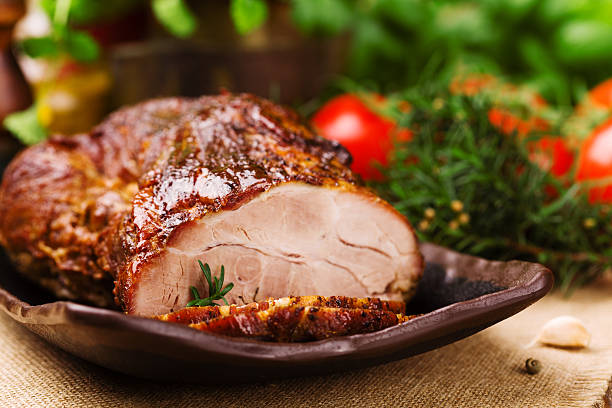 istock Roast pork with herbs and vegetables. 547520810