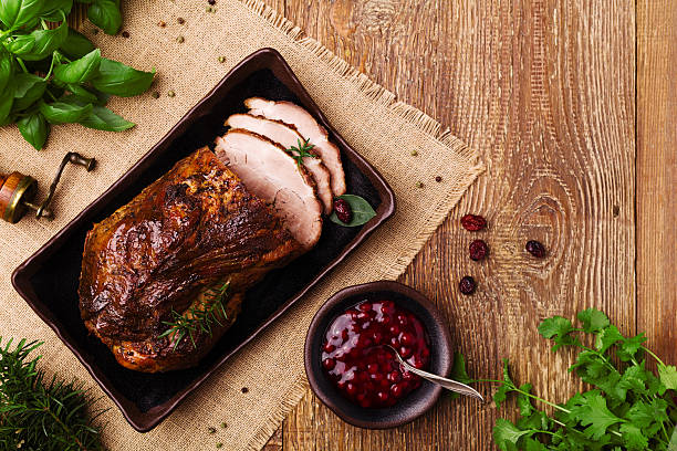 istock Roast pork with cranberry dip, basil, coriander and rosemary. 547520964