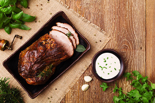 istock Roast pork with garlic dip and herbs. 547521064