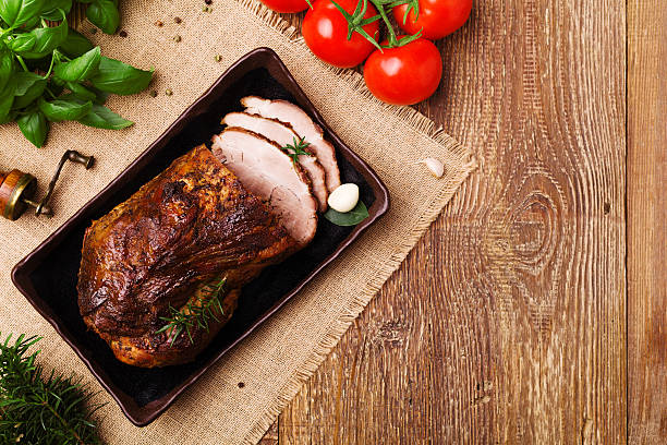 istock Roast pork with herbs and vegetables. 547521156