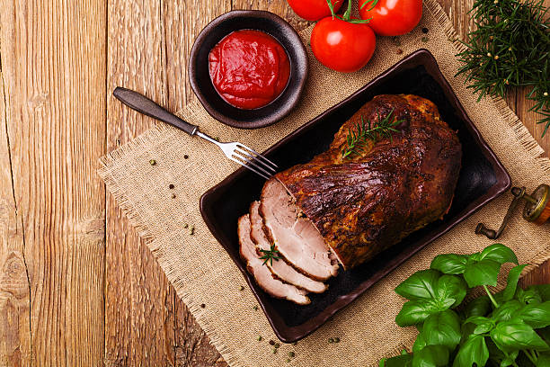 istock Roast pork with tomato dip and herbs. 547521242