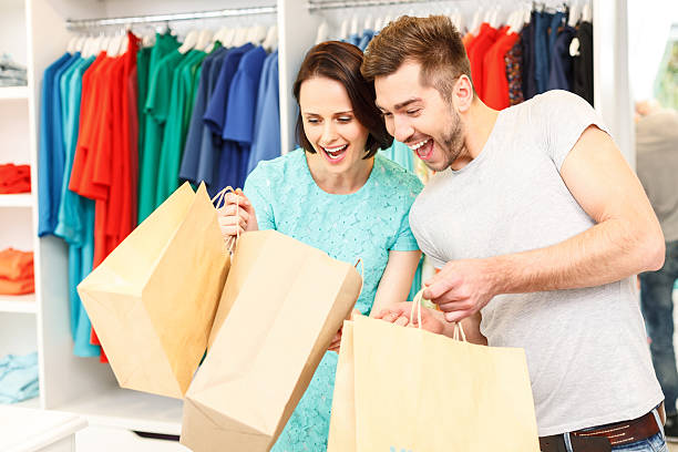 istock Joyful boyfriend and girlfriend purchasing in boutique 547521416