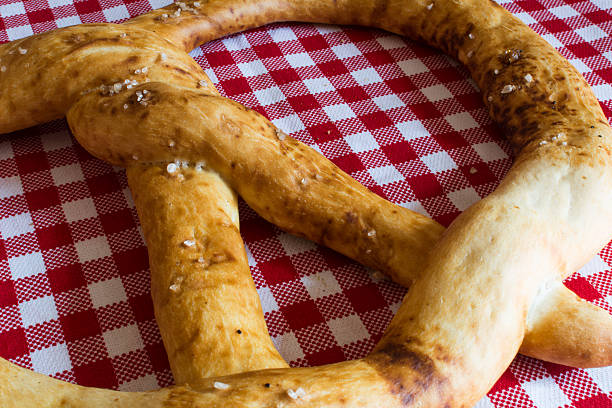 istock Artisanal cakes, big pretzel white flour sprinkled with salt 547521870