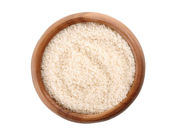 istock broken rice in a wooden bowl. 547521876