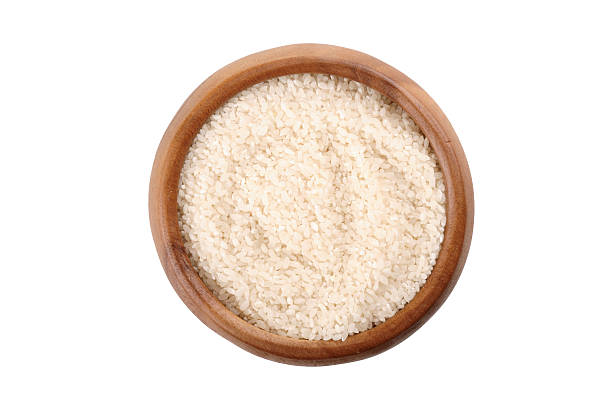istock broken rice in a wooden bowl. 547521944