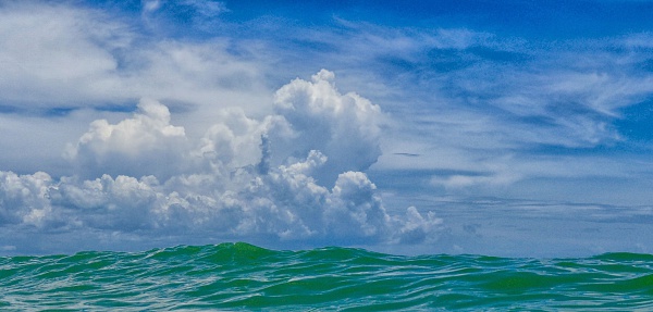 Clouds roll in as the surf gently rises on the Gulf Coast of Florida, although it could have been taken in any tropical location. 