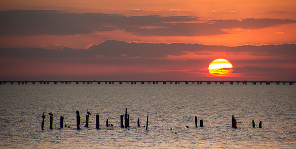 The sun setting behind the causeway over Lake Pontchartrain