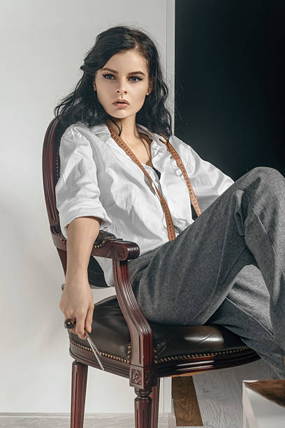 istock Fashion designer sitting with scissors in her hand. 547526692