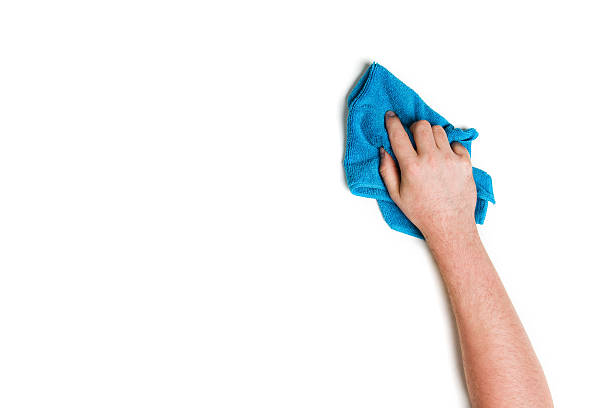 Hand cleaning against a white background Man's or woman's hand cleaning on a white background. microfiber stock pictures, royalty-free photos & images