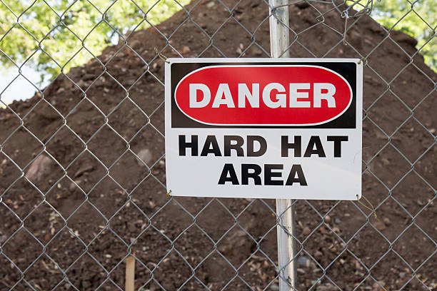 istock Danger Hard Hat area sign in front of dirt pile 547527640