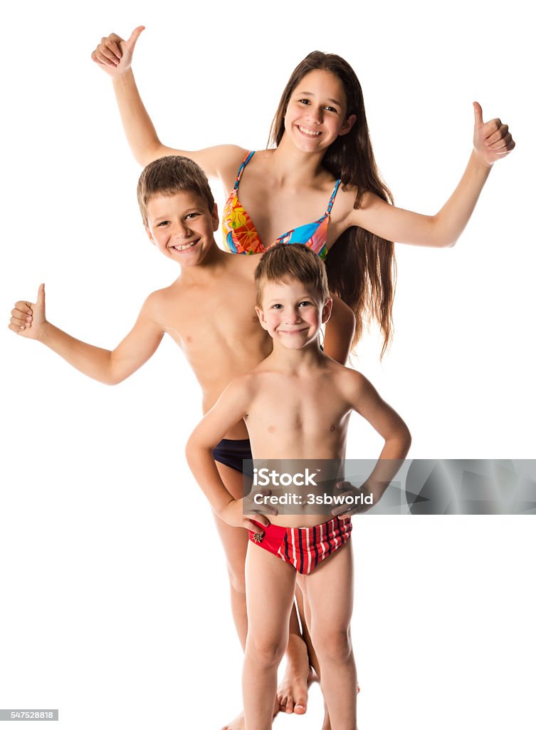 Three happy kids in swimsuit standing together Three happy kids in swimsuit standing together, isolated on white Family Stock Photo
