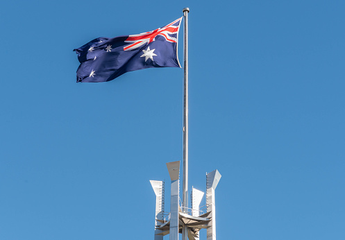 Flag flying over the Australia Parliament Building in the capital of Canberra