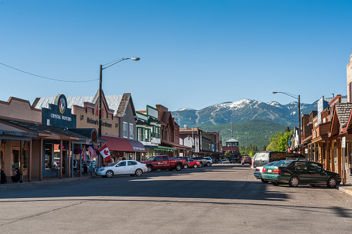 Whitefish, Montana, USA - May 29, 2009 : view of the main street of Whitefish city in Montana with houses, stores, cars