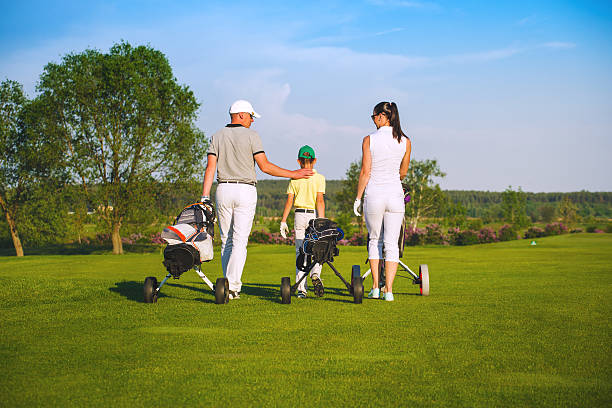 Family playing golf stock photo