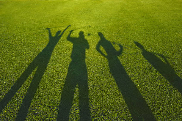 four golfers silhouette on grass - human hand child abstract adult imagens e fotografias de stock