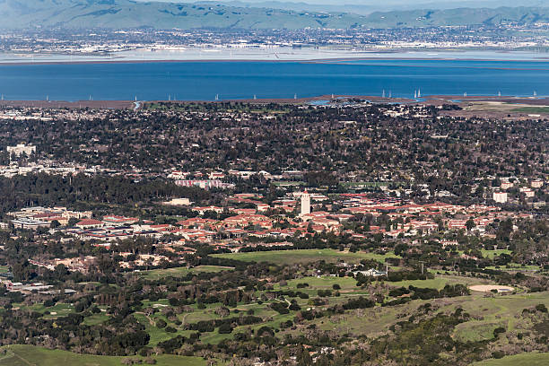 Stanford University The red-tile roofs of Stanford University stand out from the surrounding buildings in Palo Alto, California with the San Francisco Bay in the background.  The red-domed Hoover Tower rises above the surrounding buildings.  The football stadium is visible on the edge of campus.  Part of the Stanford Golf Course is visible in the foreground. stanford university photos stock pictures, royalty-free photos & images